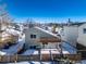 House exterior with backyard and pergola in winter at 9485 Joyce Ln, Highlands Ranch, CO 80126