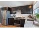 Updated kitchen featuring dark cabinetry and granite countertops at 9485 Joyce Ln, Highlands Ranch, CO 80126