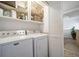 Laundry room with washer, dryer, and storage shelves at 9485 Joyce Ln, Highlands Ranch, CO 80126