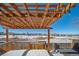 Pergola with string lights overlooking a snowy backyard at 9485 Joyce Ln, Highlands Ranch, CO 80126