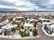 Luxury home on a tree-lined street in a snow covered neighborhood at 1365 Gentry Pl, Castle Rock, CO 80104