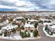 Luxury homes in a snow covered neighborhood with city views at 1365 Gentry Pl, Castle Rock, CO 80104