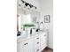 Double vanity bathroom with marble countertops and modern lighting at 1365 Gentry Pl, Castle Rock, CO 80104