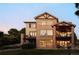 Two story home with stone and stucco siding, a deck, and backyard at 1365 Gentry Pl, Castle Rock, CO 80104