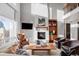 Bright living room with a fireplace, high ceilings, and large windows at 1365 Gentry Pl, Castle Rock, CO 80104