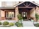 Covered porch with stone accents and a black door at 1365 Gentry Pl, Castle Rock, CO 80104