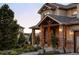 Stone porch with a covered entrance and landscaping at 1365 Gentry Pl, Castle Rock, CO 80104