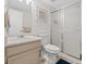 Well-lit bathroom with vanity, toilet, and shower with sliding glass doors at 15498 E Dorado Pl, Centennial, CO 80015