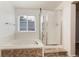 Bathroom with soaking tub, shower, window, and tiled floor at 15498 E Dorado Pl, Centennial, CO 80015