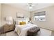 This cozy bedroom features a plush bed, nightstand with lamp, neutral walls, and window with privacy shades at 15498 E Dorado Pl, Centennial, CO 80015
