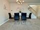 Carpeted dining room featuring modern table, chairs, decor, and a decorative chandelier at 15498 E Dorado Pl, Centennial, CO 80015