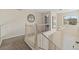 Open hallway with carpeted floor, white railing, and decor at 15498 E Dorado Pl, Centennial, CO 80015