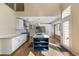 Bright kitchen with a center island, white cabinetry, stainless steel appliances, and hardwood floors at 15498 E Dorado Pl, Centennial, CO 80015