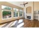 Living room with a fireplace, hardwood floors, large windows, and natural light at 15498 E Dorado Pl, Centennial, CO 80015