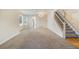 Carpeted living room with a staircase and natural light at 15498 E Dorado Pl, Centennial, CO 80015