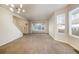 Bright living room features neutral tones, carpet flooring, and natural light from large windows at 15498 E Dorado Pl, Centennial, CO 80015
