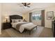 Comfortable main bedroom with a large window, upholstered bed, and neutral decor at 15498 E Dorado Pl, Centennial, CO 80015