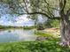 Scenic pond view with mature trees and lush green landscape at 15498 E Dorado Pl, Centennial, CO 80015