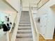Carpeted staircase with white wooden railings leading to the upper level at 15498 E Dorado Pl, Centennial, CO 80015