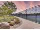 View of the community tennis court, with sidewalks, landscaping, and fencing at 15498 E Dorado Pl, Centennial, CO 80015