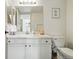Bright bathroom featuring a vanity with white cabinets, a large mirror, and modern fixtures at 8422 Everett Way # C, Arvada, CO 80005