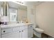Bright bathroom featuring a vanity with white cabinets, a large mirror, and modern fixtures at 8422 Everett Way # C, Arvada, CO 80005