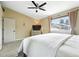 Bright bedroom with a ceiling fan, a large window, and ample closet space, creating a comfortable retreat at 8422 Everett Way # C, Arvada, CO 80005