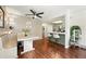 Cozy dining area with white table, booth seating, and modern ceiling fan, seamlessly connected to the kitchen at 8422 Everett Way # C, Arvada, CO 80005