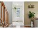 Inviting entryway featuring tiled floors, a hanging plant, and a staircase at 8422 Everett Way # C, Arvada, CO 80005