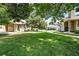 Exterior yard view with mature trees and manicured lawns at 8422 Everett Way # C, Arvada, CO 80005