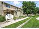 Beautiful townhome exterior with charming courtyard, flowers, and a well-manicured lawn at 8422 Everett Way # C, Arvada, CO 80005