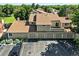Two-story condo complex with garages, manicured bushes, and parking in front of a tree-filled neighborhood at 8422 Everett Way # C, Arvada, CO 80005