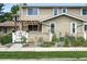 Inviting townhome exterior with a cozy courtyard, metal planters, and white picket fence at 8422 Everett Way # C, Arvada, CO 80005