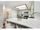 Modern kitchen with stainless steel appliances, sleek countertops, stylish stools, and bright lighting at 8422 Everett Way # C, Arvada, CO 80005