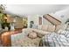 Spacious living room featuring hardwood floors, a large sectional, and an open floor plan at 8422 Everett Way # C, Arvada, CO 80005