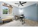 Inviting home office with a large window, modern ceiling fan and desk, offering a comfortable workspace at 8422 Everett Way # C, Arvada, CO 80005