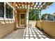 Charming patio with a wooden pergola, offering shaded outdoor space for relaxation and entertaining at 8422 Everett Way # C, Arvada, CO 80005