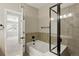 Bathroom with a tub and shower combo featuring neutral wall tiling at 31112 Black Eagle Dr # 103, Evergreen, CO 80439