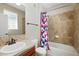 Bathroom featuring tile floors, a combination tub and shower, and modern fixtures at 31112 Black Eagle Dr # 103, Evergreen, CO 80439