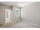 Empty bedroom featuring neutral colored walls, plush carpeting, and a window at 31112 Black Eagle Dr # 103, Evergreen, CO 80439