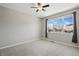 Neutral bedroom with a large window allowing natural light and views at 31112 Black Eagle Dr # 103, Evergreen, CO 80439