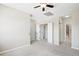 Spacious bedroom with a ceiling fan and access to multiple closets and doorways at 31112 Black Eagle Dr # 103, Evergreen, CO 80439
