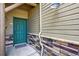 Charming front entryway with craftsman-style door, stone accents, and a welcoming doormat at 31112 Black Eagle Dr # 103, Evergreen, CO 80439