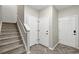 Hallway and staircase with neutral walls and carpet and wood look flooring at 31112 Black Eagle Dr # 103, Evergreen, CO 80439