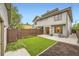 Backyard featuring artificial turf, concrete patio, garden beds, and privacy fence at 2442 S Bannock St, Denver, CO 80223