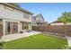 Backyard boasting artificial turf, concrete patio, garden beds, and privacy fence at 2442 S Bannock St, Denver, CO 80223
