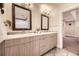 Bathroom featuring double sinks, vanity, and large mirrors at 2442 S Bannock St, Denver, CO 80223