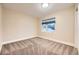 Bright bedroom featuring neutral walls, carpet, and a window providing natural light at 2442 S Bannock St, Denver, CO 80223