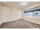 Neutral bedroom with a window allowing in natural light, and two white doors at 2442 S Bannock St, Denver, CO 80223