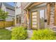 Up close view of the door and entranceway with professional landscaping and visible house numbers at 2442 S Bannock St, Denver, CO 80223